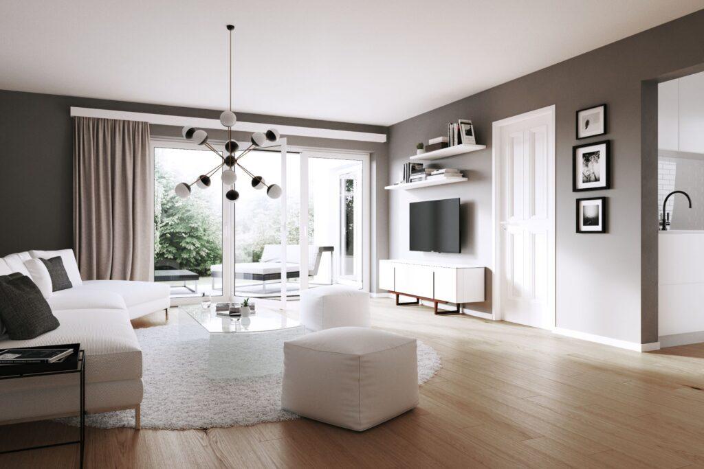 Ein helles, modernes Wohnzimmer mit einem minimalistischen Lowboard unter dem Fernseher. Das elegante Lowboard in Weiß fügt sich nahtlos in den Raum ein und bietet Stauraum, während die große Fensterfront viel natürliches Licht hereinlässt. Neutrale Farben und moderne Möbel schaffen eine ruhige, stilvolle Atmosphäre.