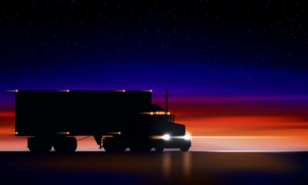 Lastwagen mit eingeschalteter Lkw Beleuchtung bei Nachtfahrt unter Sternenhimmel